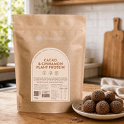 Cacao and Cinnamon Plant Protein 750g pouch beside homemade chocolate energy balls