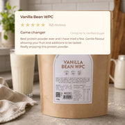 Vanilla Bean WPC customer review above a vanilla protein shake and product pouch
